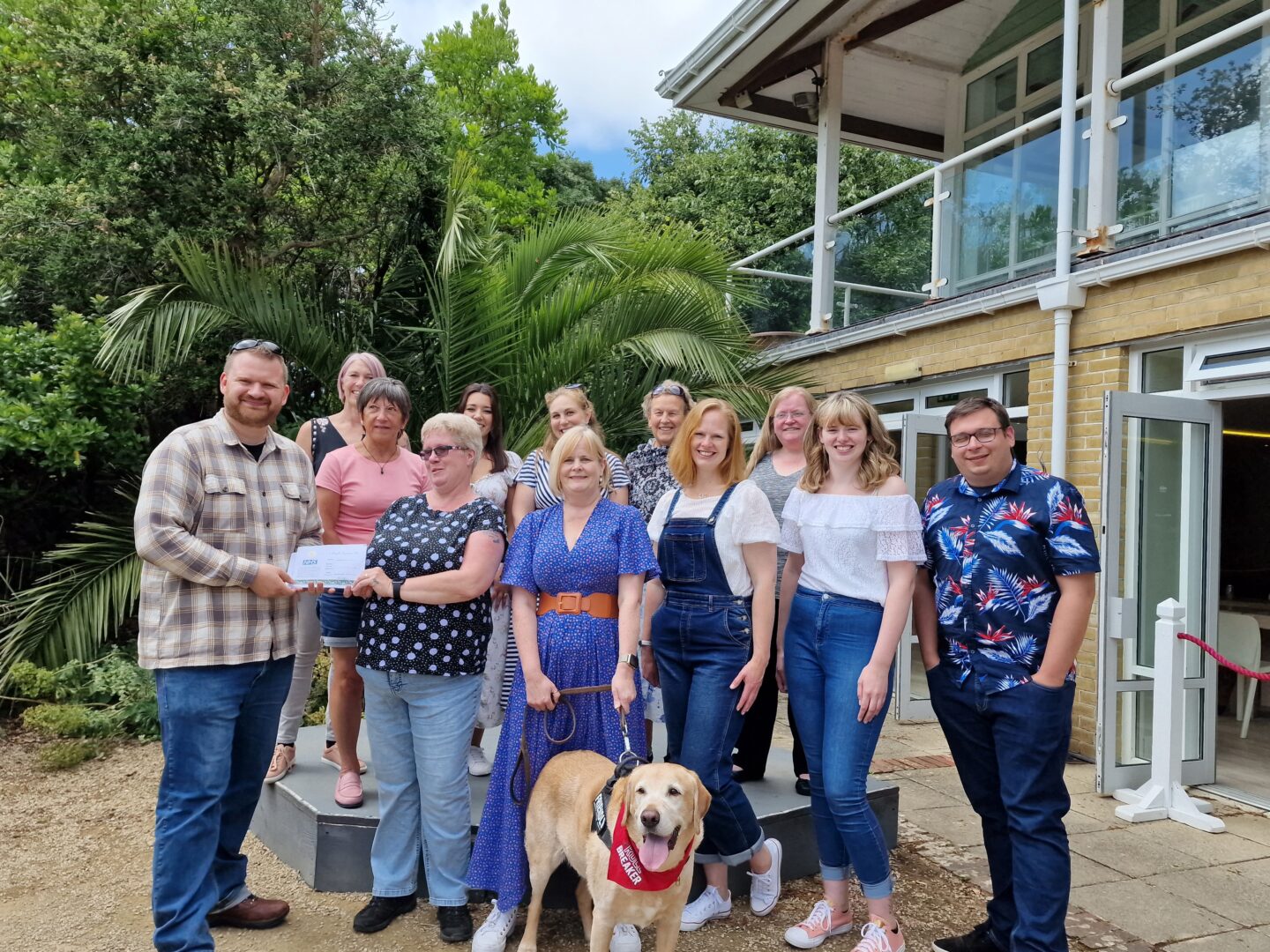 Marketing manager Kai Davis presenting the first batch of recovery passes to the medical staff from St Mary's Hospital on site at Ventnor Botanic Garden